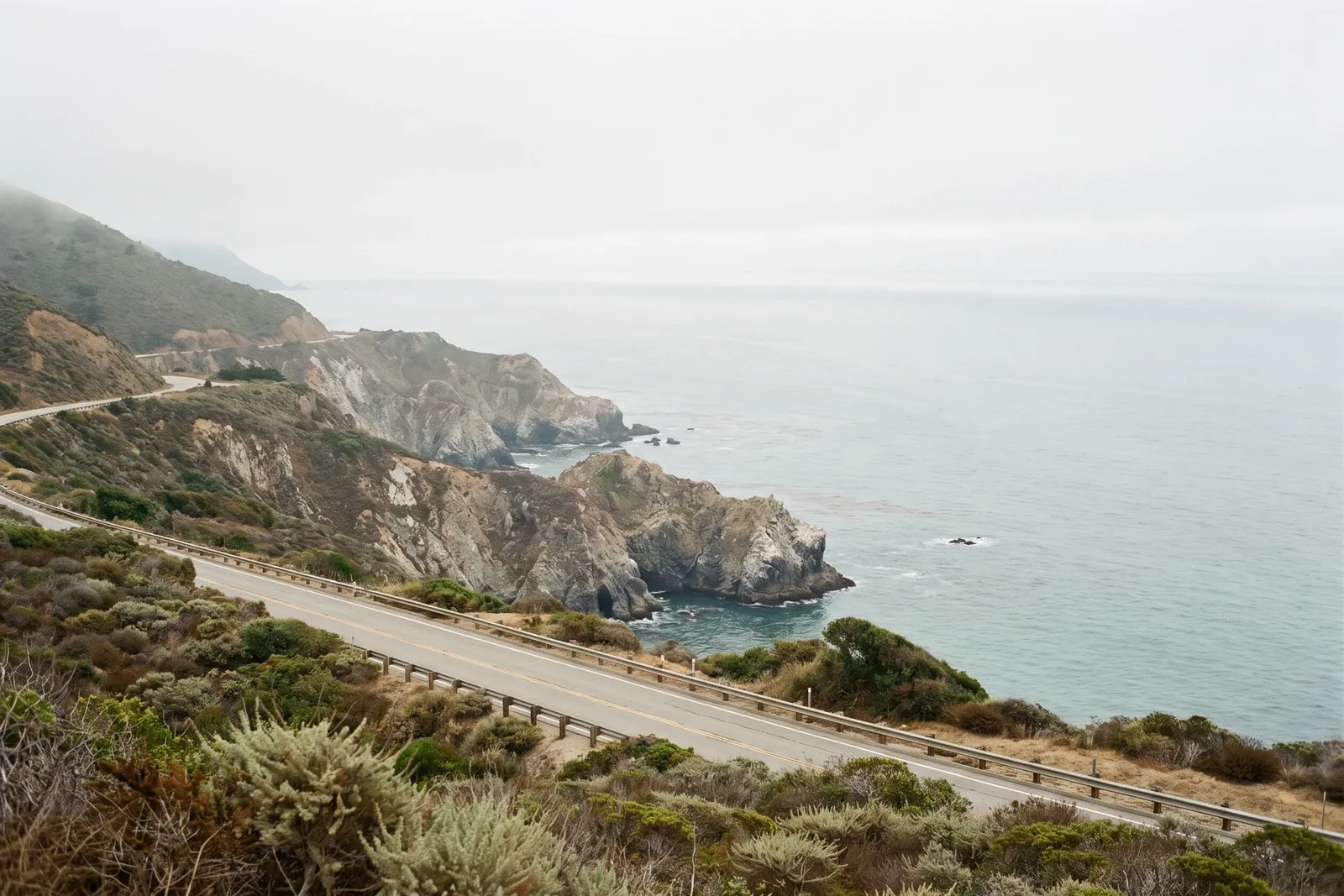 Muted Pacific coastline and coastal road along California's Big Sur region