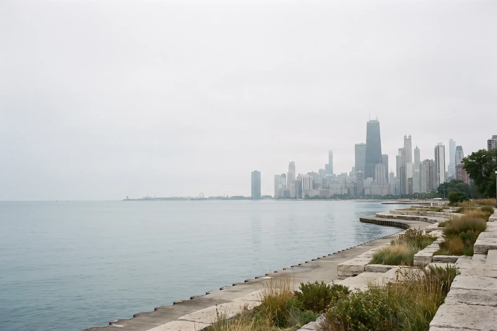 Chicago lakefront with calm Lake Michigan and a restrained city skyline